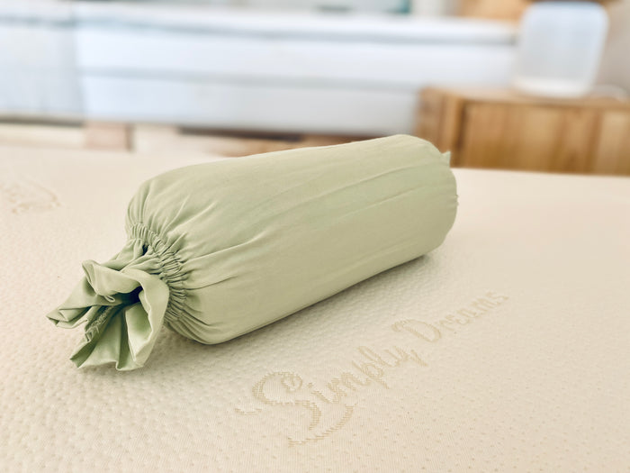 side of bolster pillow with green bolster case