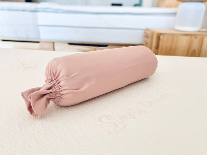 pink-colored organic bamboo lyocell baby bolster casewith ruffled ends