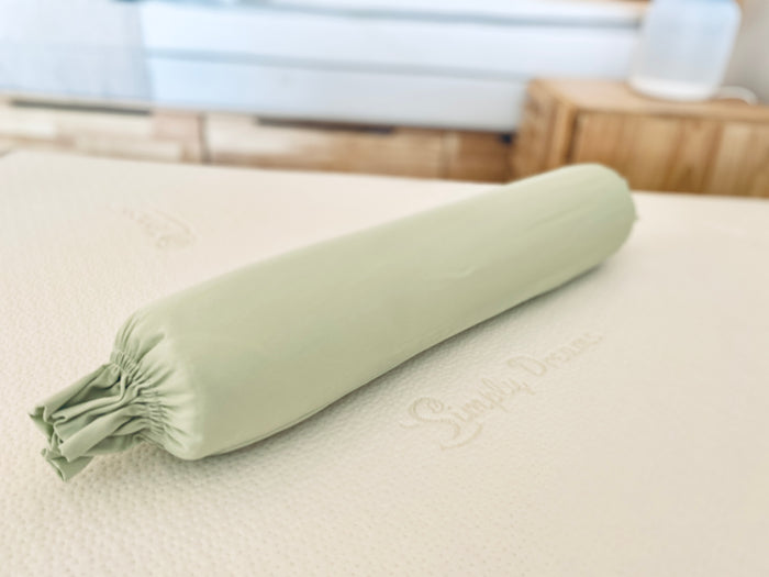 Top-down view of a green organic bamboo lyocell baby bolster case