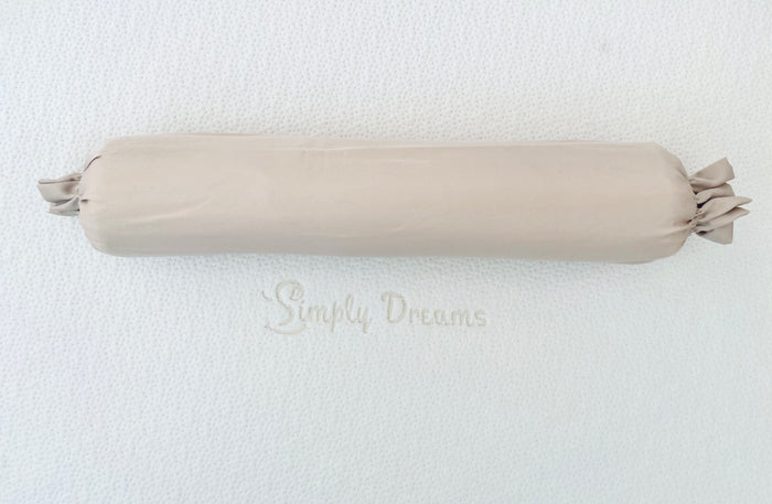 A beige-colored organic bamboo lyocell baby bolster cover displayed on a white mattress with the Simply Dreams logo.