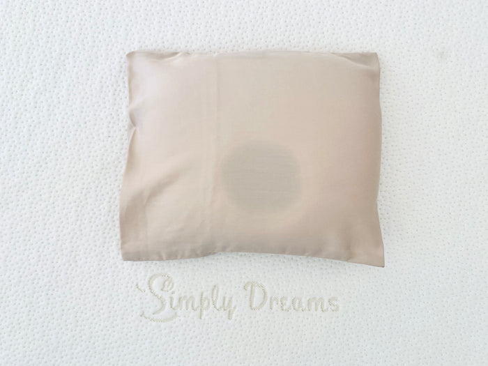 A beige-colored baby head-shaping pillowcase crafted from organic bamboo lyocell