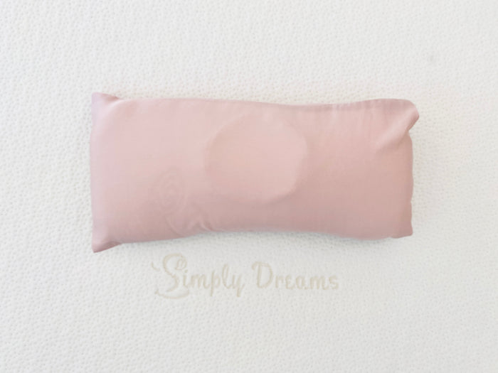 Top-down view of a pink-colored organic bamboo lyocell baby head-shaping pillowcase